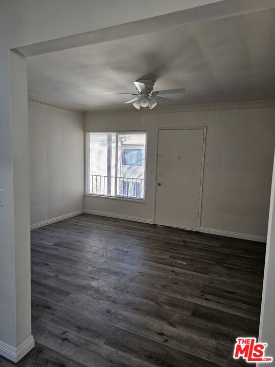 spare room featuring ceiling fan and dark hardwood / wood-style flooring