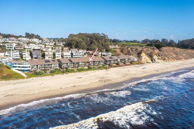 birds eye view of property with a view of the beach and a water view