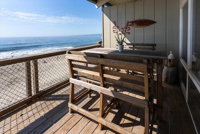 exterior space featuring a water view and a view of the beach