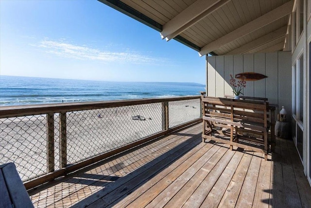 balcony featuring a water view and a view of the beach