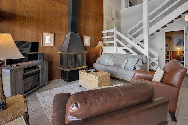 tiled living room featuring wooden walls