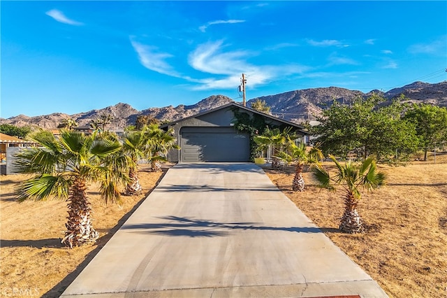 ranch-style home featuring a mountain view and a garage