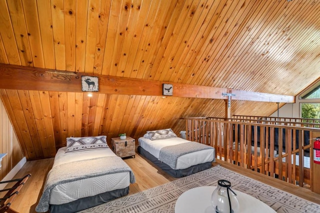 bedroom featuring vaulted ceiling, light hardwood / wood-style flooring, wood ceiling, and wood walls