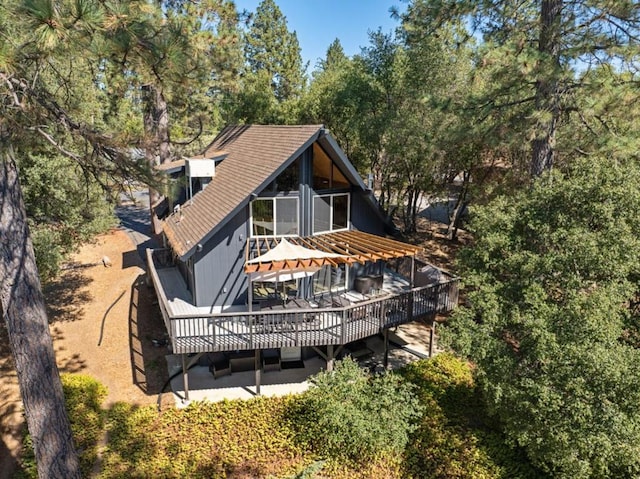 rear view of house featuring a wooden deck