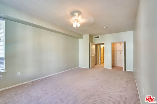 unfurnished bedroom with ceiling fan and light colored carpet