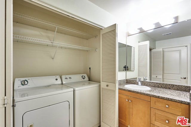 washroom featuring washer and clothes dryer and sink