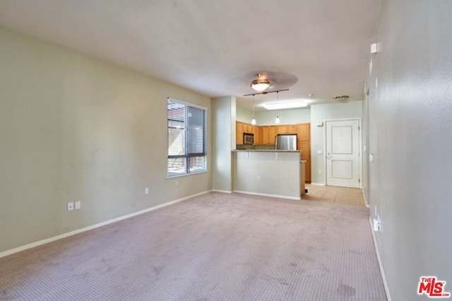 unfurnished living room featuring light colored carpet