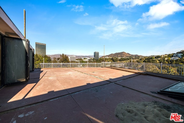 view of patio / terrace featuring a mountain view