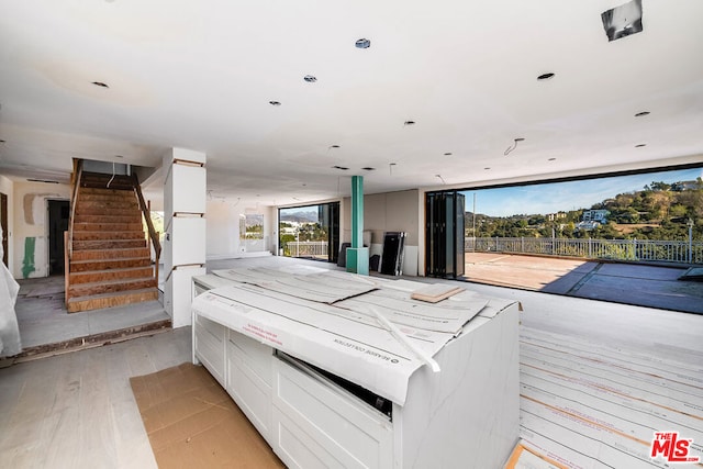 interior space with white cabinetry and light wood-type flooring