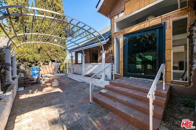 entrance to property with a patio