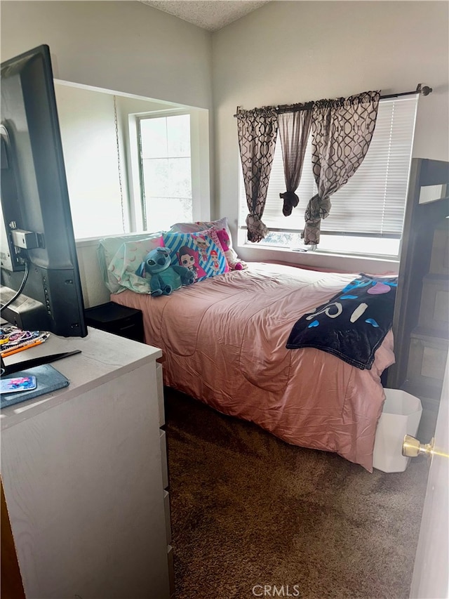 bedroom with a textured ceiling and carpet