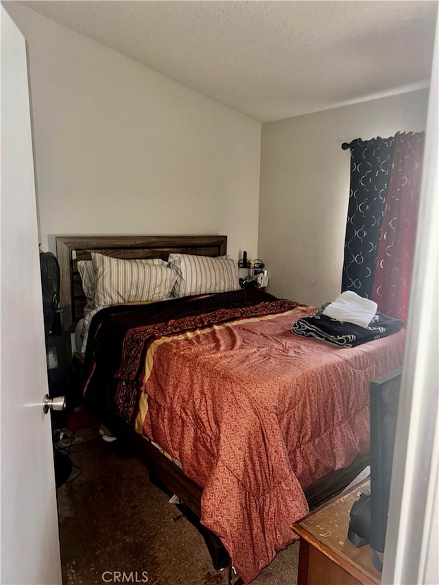 carpeted bedroom featuring a textured ceiling