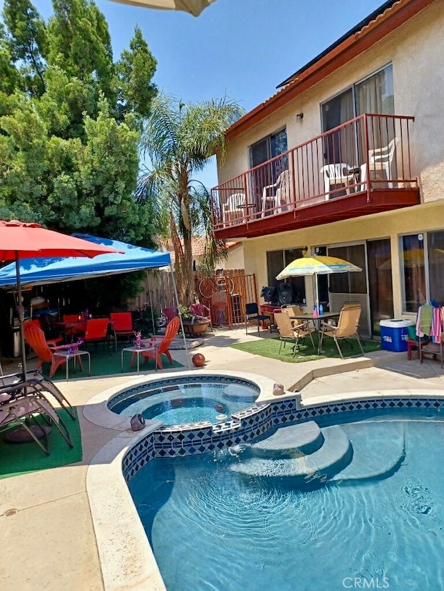 view of pool featuring an in ground hot tub and a patio area