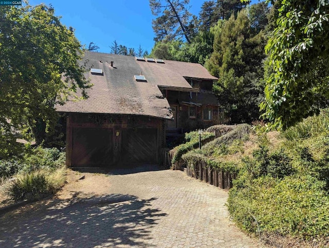 view of side of home featuring a garage