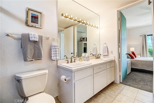 bathroom with vanity, tile patterned flooring, and toilet