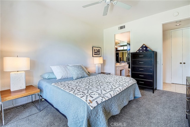 carpeted bedroom featuring ceiling fan and connected bathroom