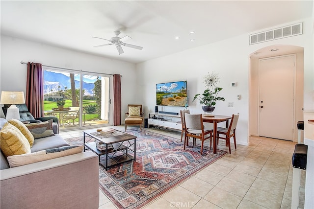 living room with ceiling fan and light tile patterned floors