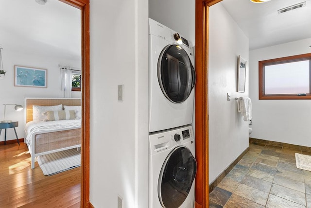 washroom with stacked washer / drying machine