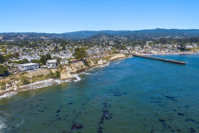 drone / aerial view with a water and mountain view