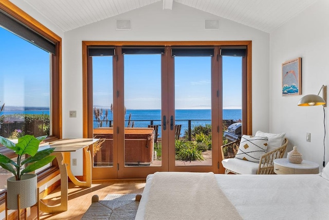 carpeted bedroom featuring multiple windows, vaulted ceiling, a water view, and access to exterior