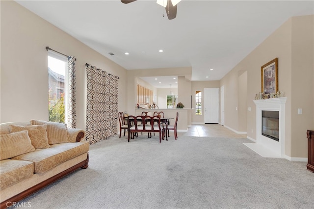 living room with ceiling fan and light carpet