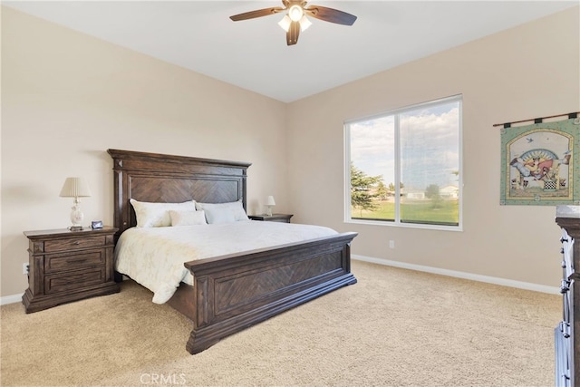 bedroom with ceiling fan and light carpet