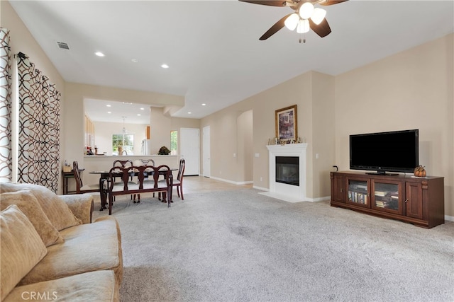 carpeted living room featuring ceiling fan