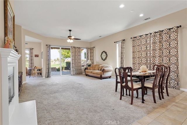 carpeted dining space featuring ceiling fan