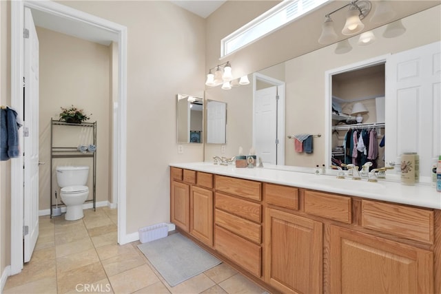 bathroom featuring vanity, tile patterned flooring, and toilet