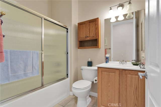 full bathroom with bath / shower combo with glass door, vanity, tile patterned flooring, and toilet