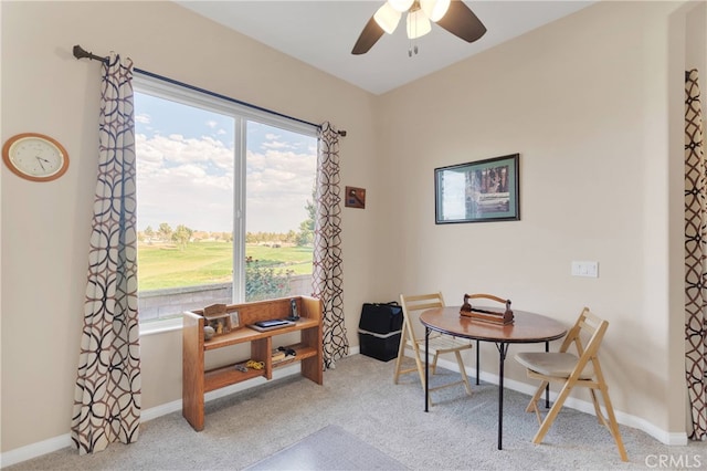 office featuring plenty of natural light, ceiling fan, and light carpet