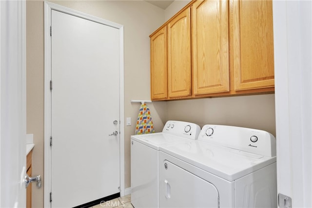 laundry room with cabinets, independent washer and dryer, and light tile patterned flooring