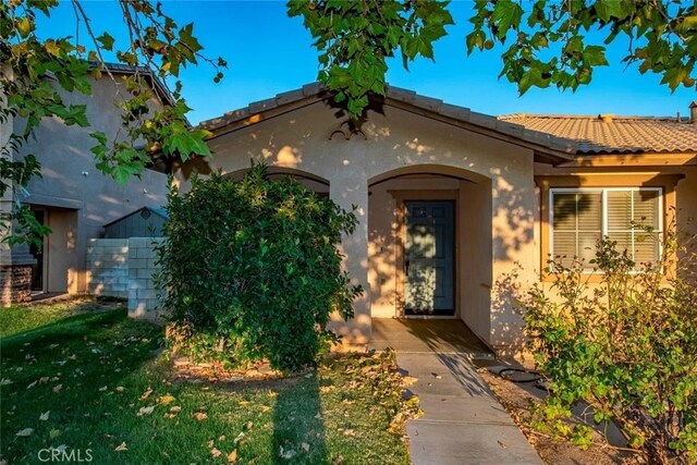 doorway to property with a yard