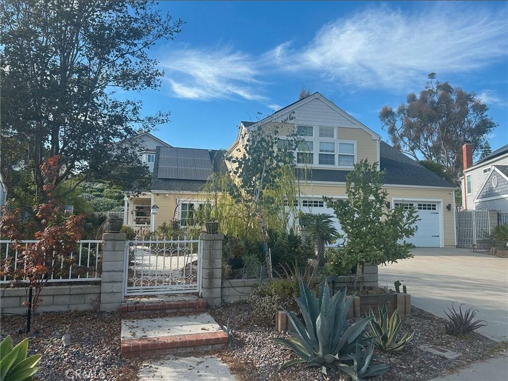 view of front of property featuring a garage and solar panels