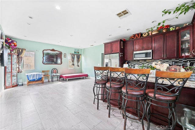 kitchen with backsplash and appliances with stainless steel finishes