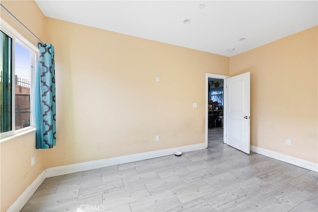 spare room with light hardwood / wood-style flooring