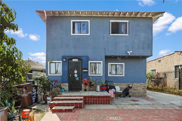 back of house with a patio