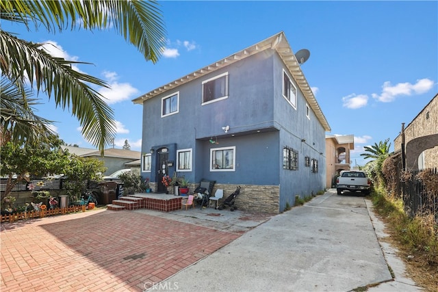 rear view of property featuring a patio area