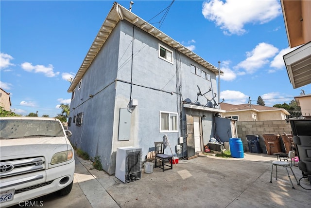 rear view of property featuring electric panel and a patio