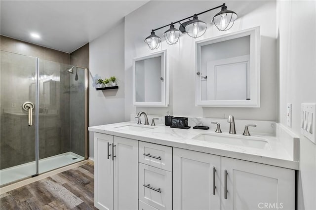 24120 Manzanita St, Menifee, CA 92584 - full bath with double vanity, a sink, wood finished floors, and a stall shower