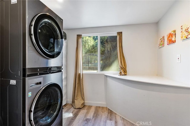 24120 Manzanita St, Menifee, CA 92584 - laundry room featuring baseboards, laundry area, stacked washer / dryer, and wood finished floors