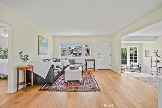 living room featuring baseboards and light wood finished floors