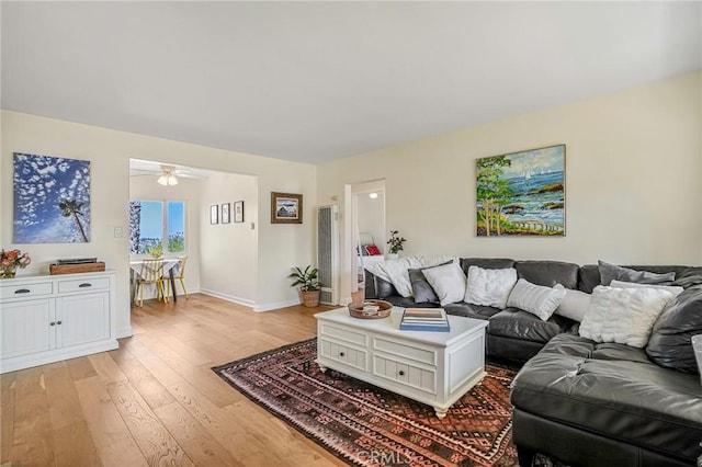 living room with ceiling fan and light wood-type flooring