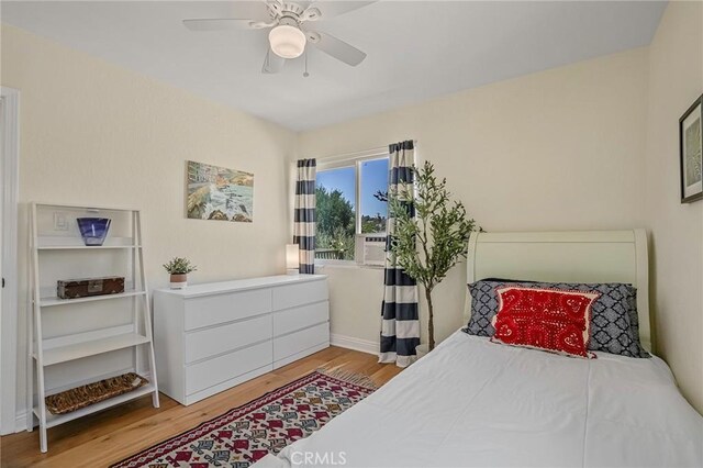 bedroom with ceiling fan and light hardwood / wood-style floors