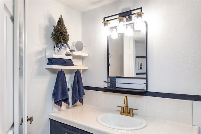 bathroom featuring vanity and tasteful backsplash