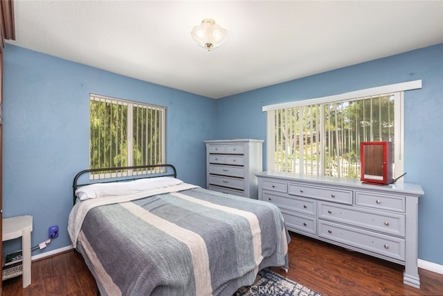 bedroom with dark wood-type flooring