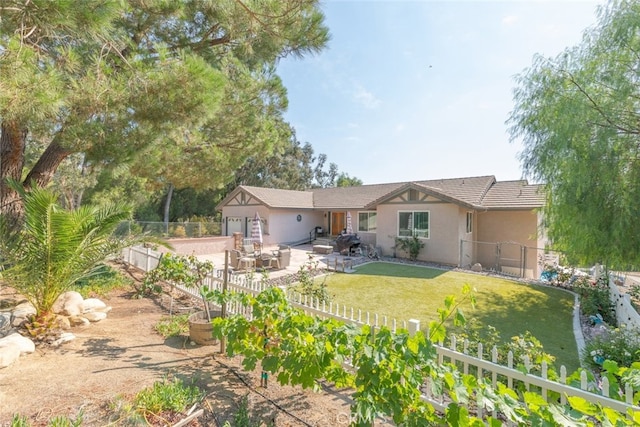 back of house featuring a lawn and a patio area