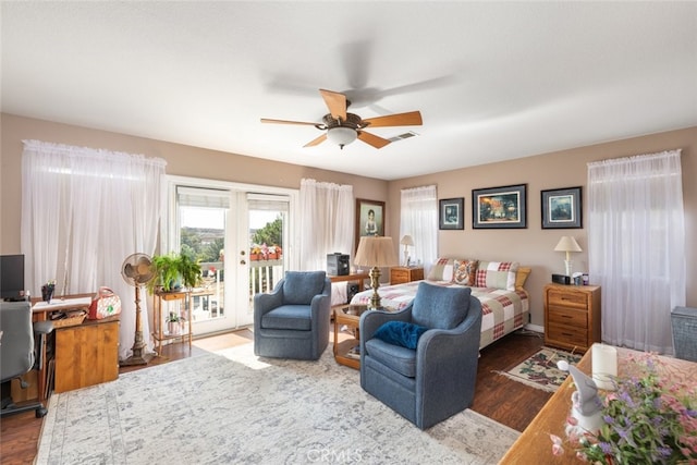 bedroom featuring access to exterior, french doors, dark hardwood / wood-style flooring, and ceiling fan