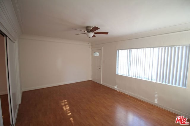 spare room with ceiling fan, hardwood / wood-style flooring, and ornamental molding