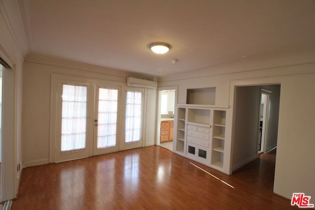 spare room with french doors, a wall mounted AC, dark hardwood / wood-style flooring, and ornamental molding